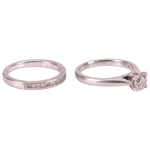 67 - A set of platinum and diamond rings; the solitaire featuring a single round brilliant-cut diamond of... 