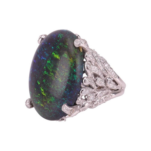 73 - A large black opal and diamond cocktail ring, featuring an oval cabochon of a black opal of 31.0 x 2... 