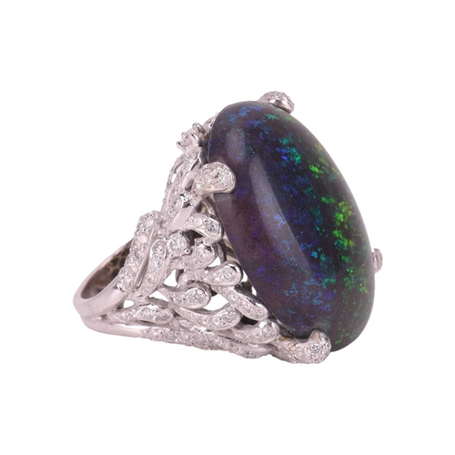 73 - A large black opal and diamond cocktail ring, featuring an oval cabochon of a black opal of 31.0 x 2... 