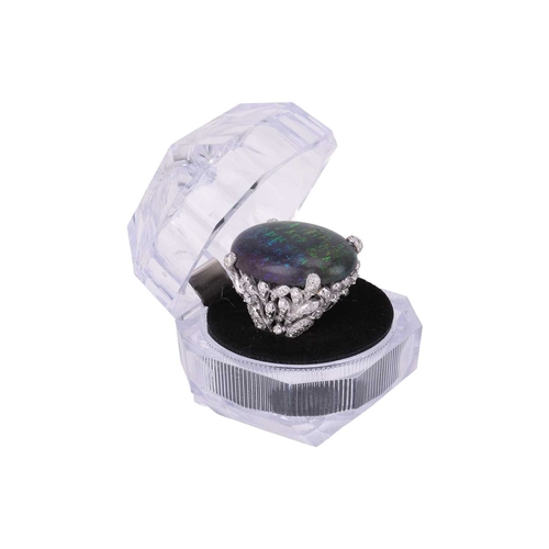 73 - A large black opal and diamond cocktail ring, featuring an oval cabochon of a black opal of 31.0 x 2... 
