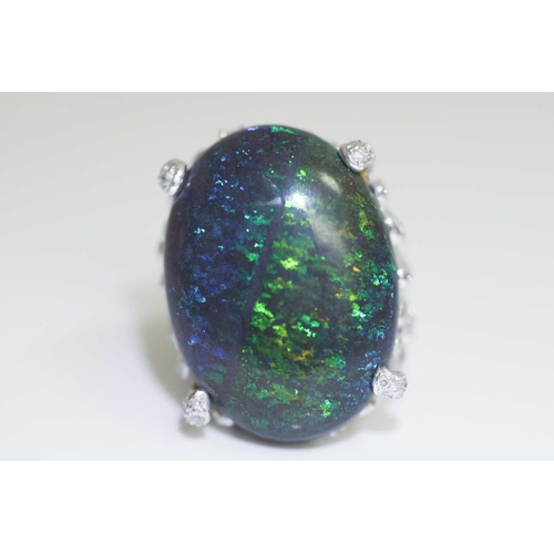 73 - A large black opal and diamond cocktail ring, featuring an oval cabochon of a black opal of 31.0 x 2... 