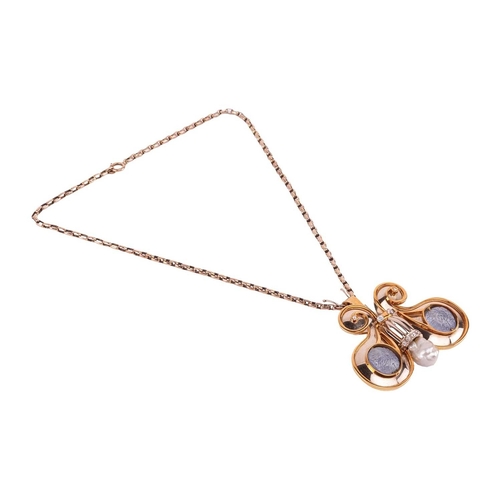 74 - A gem-set butterfly brooch in 18ct gold, the stylised butterfly with scrolled wings featuring two ca... 
