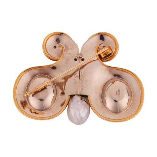 74 - A gem-set butterfly brooch in 18ct gold, the stylised butterfly with scrolled wings featuring two ca... 