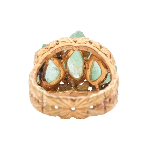 79 - Buccellati - a carved emerald dress ring of foliate design, circa 1950s, claw-set with three carved ... 