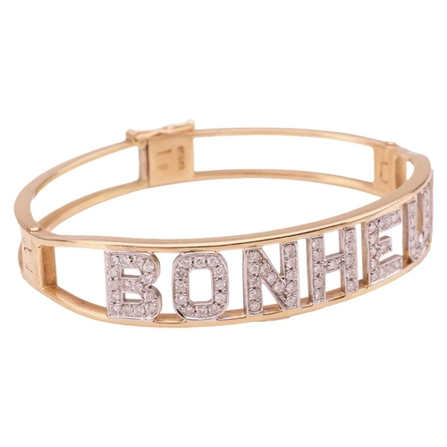 85 - A diamond-set 'Bonheur' (Happiness in French) hinged bangle, alphabets encrusted with brilliant-cut ... 