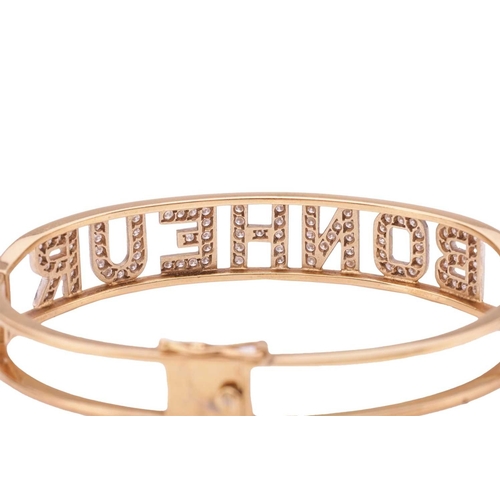 85 - A diamond-set 'Bonheur' (Happiness in French) hinged bangle, alphabets encrusted with brilliant-cut ... 
