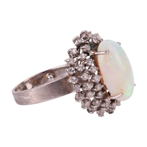 90 - An opal and diamond cluster ring, centred with an oval cabochon precious opal, displaying vibrant sp... 