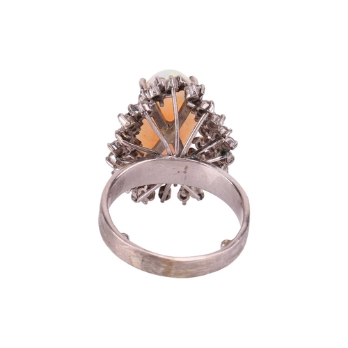 90 - An opal and diamond cluster ring, centred with an oval cabochon precious opal, displaying vibrant sp... 