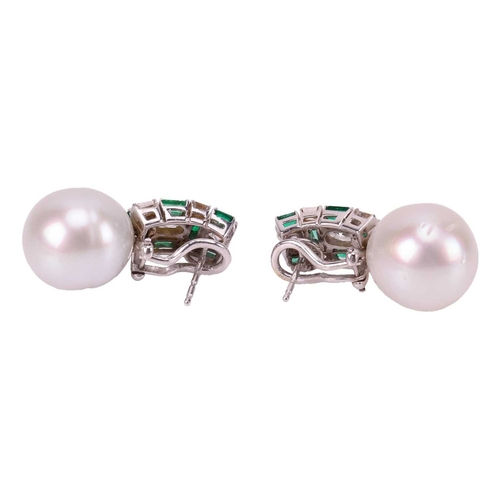 93 - A pair of pearl, emerald and diamond earrings, each features a large egg-shaped white cultured pearl... 