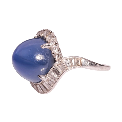 94 - A star sapphire and diamond cluster ring, comprising a claw-set high domed sapphire cabochon of medi... 