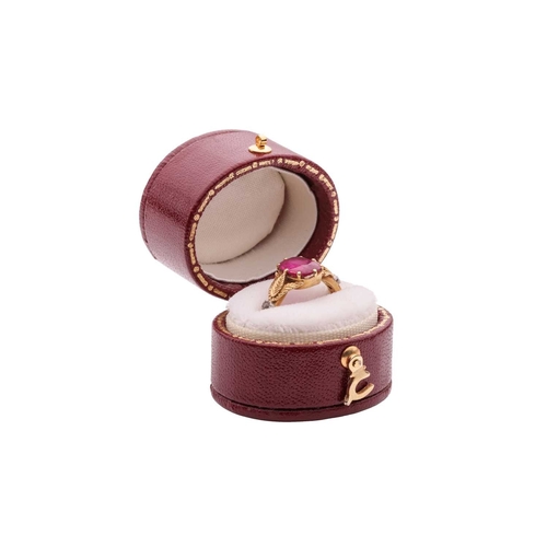 98 - An 18ct gold ruby and diamond-set ring, centred with a claw-set oval-cut ruby of vivid pinkish-red c... 