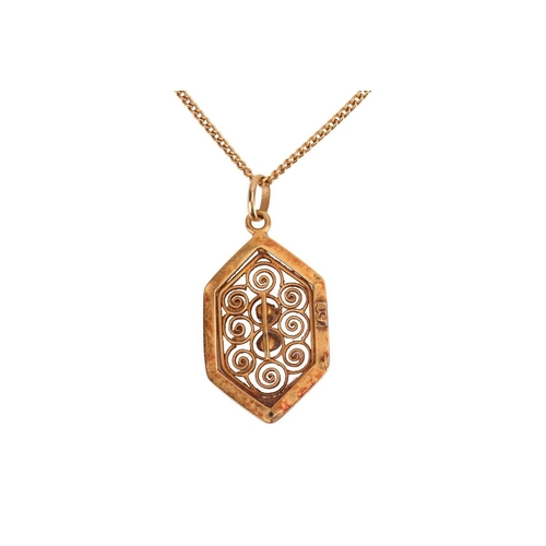 91 - A filigree pendant, the six-sided panel featuring filigree detailing of spiral design, centrally set... 