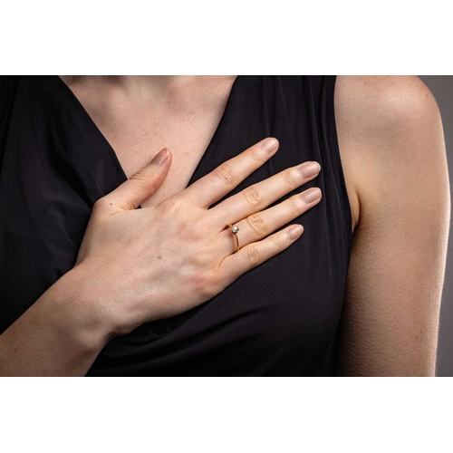 13 - A diamond solitaire ring, featuring a central claw-set old-cut diamond of estimated 0.48ct, to a tap... 