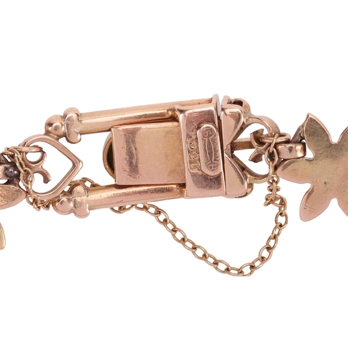 14 - A Victorian gem-set bracelet, composed of fancy links, with alternating floral and heart motifs, bez... 