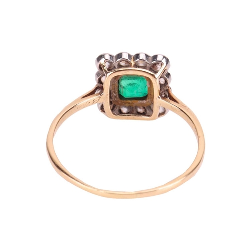 19 - An emerald and diamond cluster ring, comprising a central emerald-cut emerald collet-set in yellow m... 