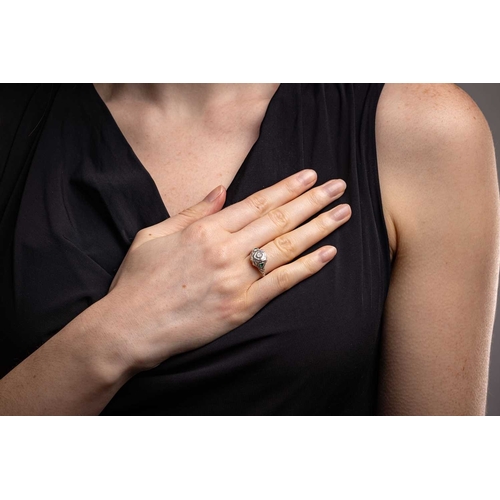 42 - An Art Deco-style ring, centrally-set with a round brilliant-cut diamond in a geometric setting with... 
