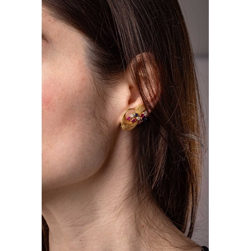 50 - Kutchinsky - A pair of gem-set clip-on earrings in 18ct yellow gold, the stylised sprays of swirl fo... 