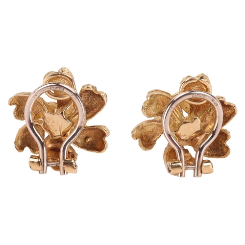 57 - A pair of floral clip-on earrings in 18ct yellow gold, by Crinnan Jewellery Ltd, the stylised flower... 