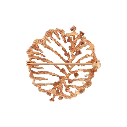 58 - An abstract brooch in 9ct yellow gold, the organically textured mount adorned with a spine of polish... 
