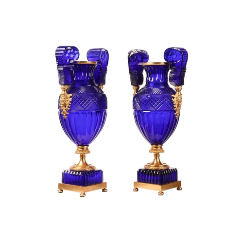 183 - A pair of large cobalt blue faceted and cut glass twin-handled vases, of Neo-classical design with o... 