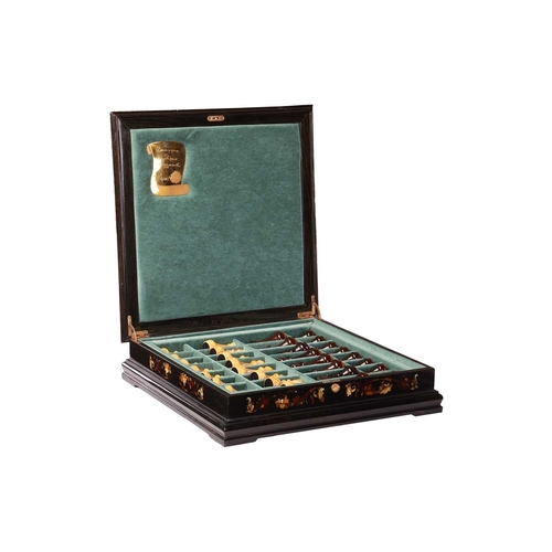 187 - A simulated amber chess set, late 20th century, the figures contained in a hardwood case with presse... 