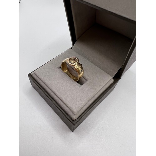 296 - 9ct Gold buckle ring set with 2 diamonds size Q 5.1g total