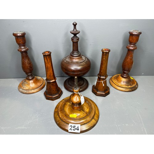 254 - Collection of treen ware to include candle sticks