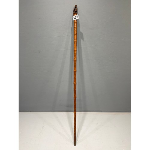 335 - Carved walking stick with buddha top