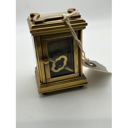 390 - Small brass carriage clock & key with picture enamel design on front & sides working