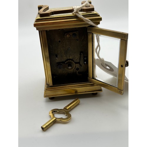 390 - Small brass carriage clock & key with picture enamel design on front & sides working