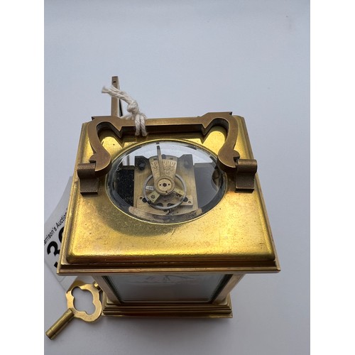 390 - Small brass carriage clock & key with picture enamel design on front & sides working