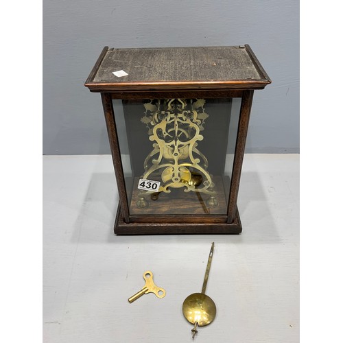 430 - Skelington clock in oak & glass cabinet