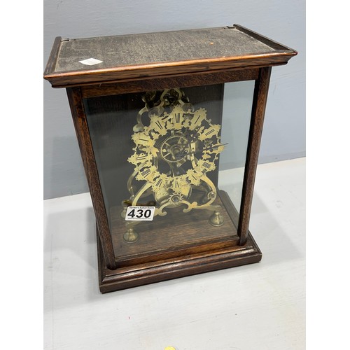 430 - Skelington clock in oak & glass cabinet