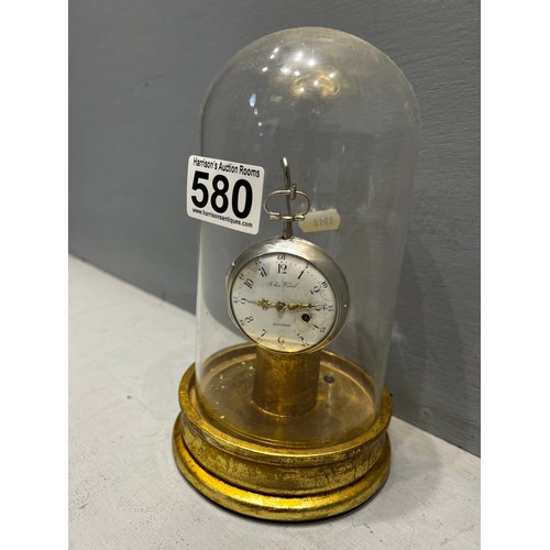 580 - Silver pocket watch on stand under glass dome