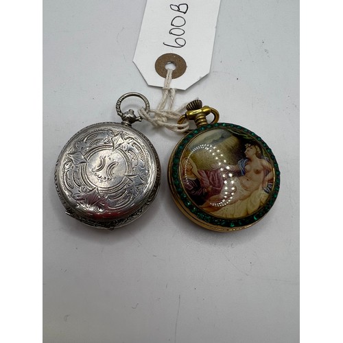 600b - 2 ornate pocket watches, one having ornate picture on the back, one is silver (both working)