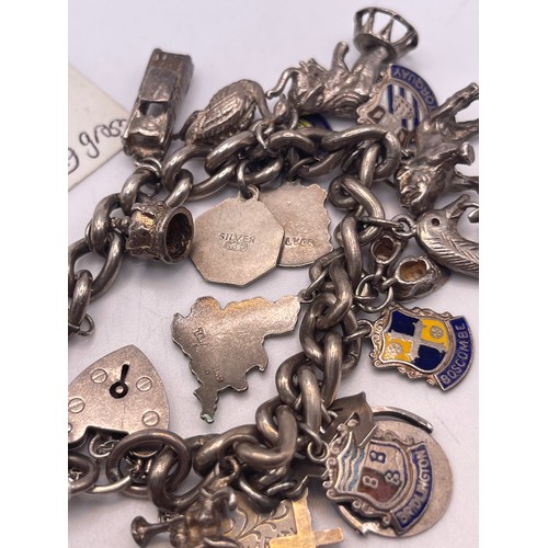 585u - Heavy silver charm bracelet 77.2g