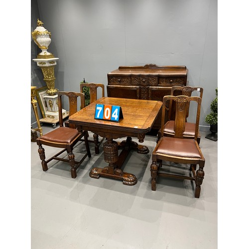 704 - Carved oak dining room suite inc drawer leaf table + 4 chairs + sideboard