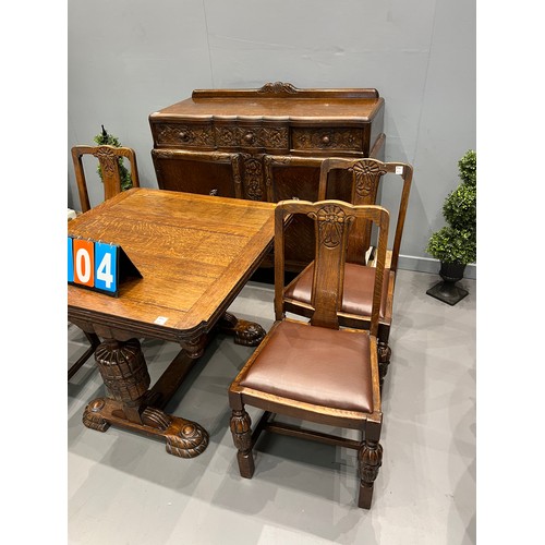 704 - Carved oak dining room suite inc drawer leaf table + 4 chairs + sideboard