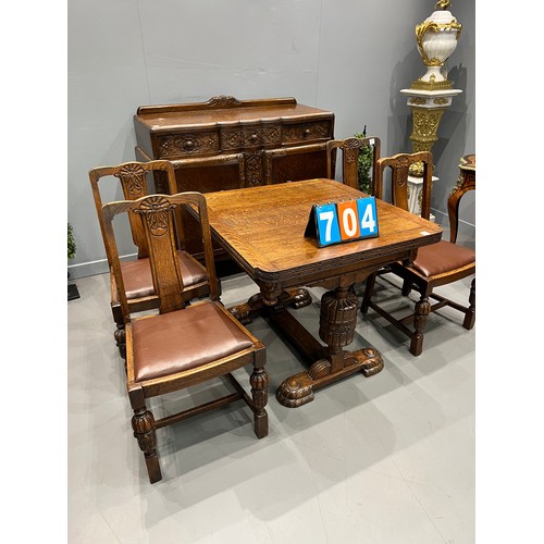 704 - Carved oak dining room suite inc drawer leaf table + 4 chairs + sideboard