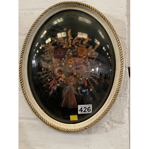 426 - Oval glass fronted plaque with flowers