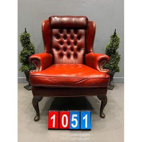 1051 - Red leather chesterfield wing back chair on cabriol leg good shape