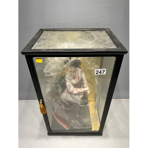 247 - Large oriental figure in display case (case damaged)