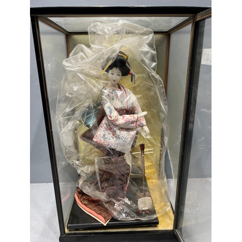 247 - Large oriental figure in display case (case damaged)