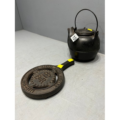 106 - E.r cast iron tea pot & stand