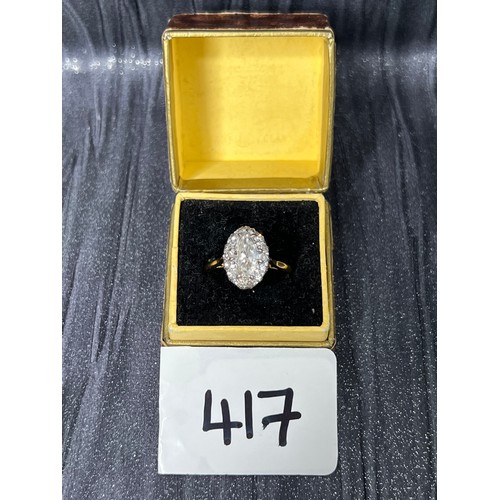 417 - 18ct Gold diamond ring oval centre stone surrounded by smaller stones size M ( centre stone between ... 