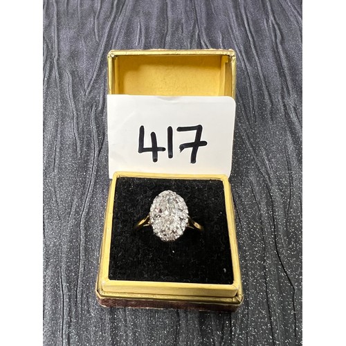 417 - 18ct Gold diamond ring oval centre stone surrounded by smaller stones size M ( centre stone between ... 