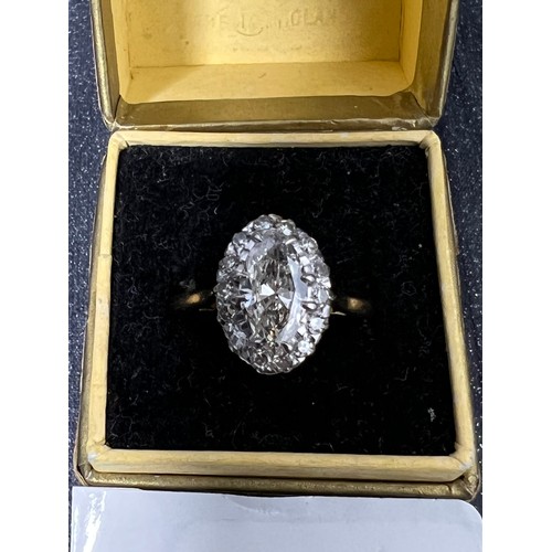 417 - 18ct Gold diamond ring oval centre stone surrounded by smaller stones size M ( centre stone between ... 