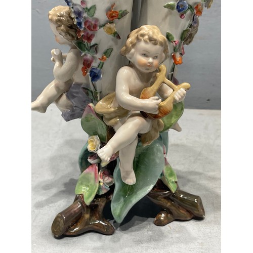 255T - Continental 3 spill vase adorned with cherubs playing musical instruments cross sword on base