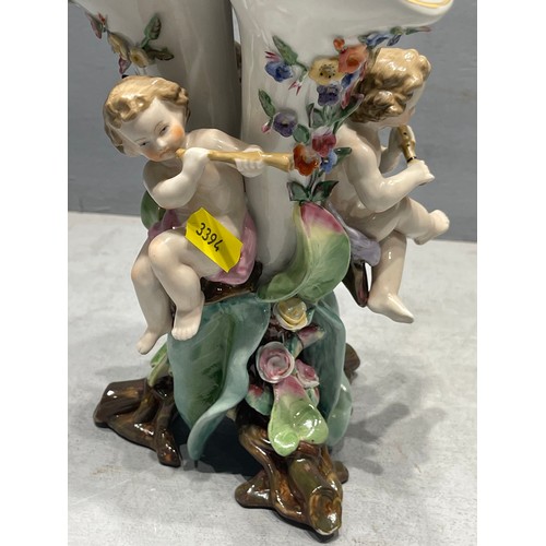 255T - Continental 3 spill vase adorned with cherubs playing musical instruments cross sword on base