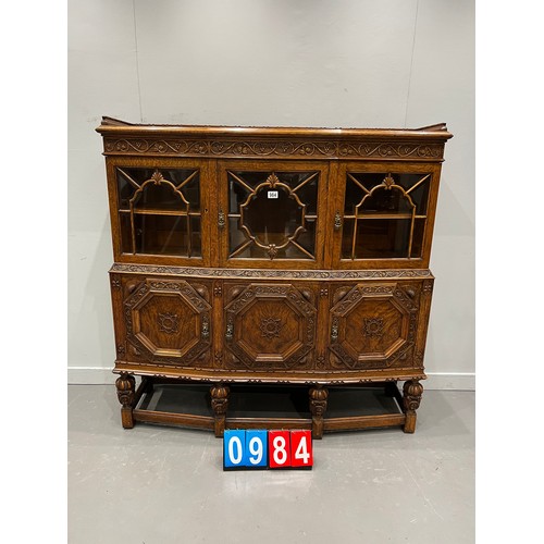 984 - Quality antique oak carved astral glazed cabinet on pineapple leg good colour